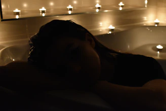 Softly lit room prepared for body treatments with aromatic candles.