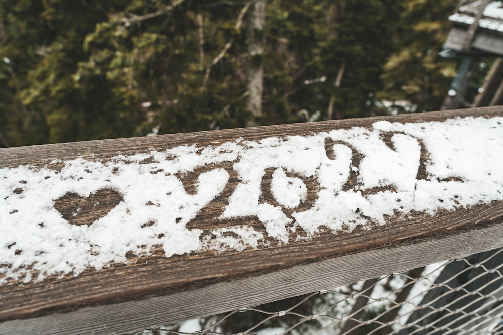 a close up of a fence with snow on it