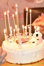 a white cake with a bunch of candles on it