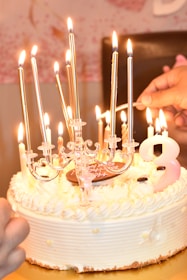 a white cake with a bunch of candles on it