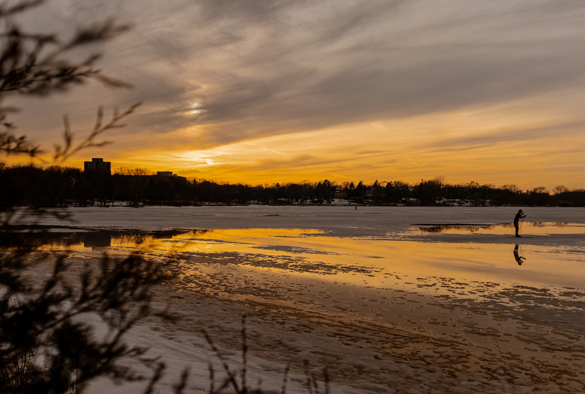 A frozen Minneapolis lake at sunset