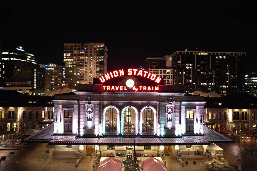 a train station lit up at night in the city