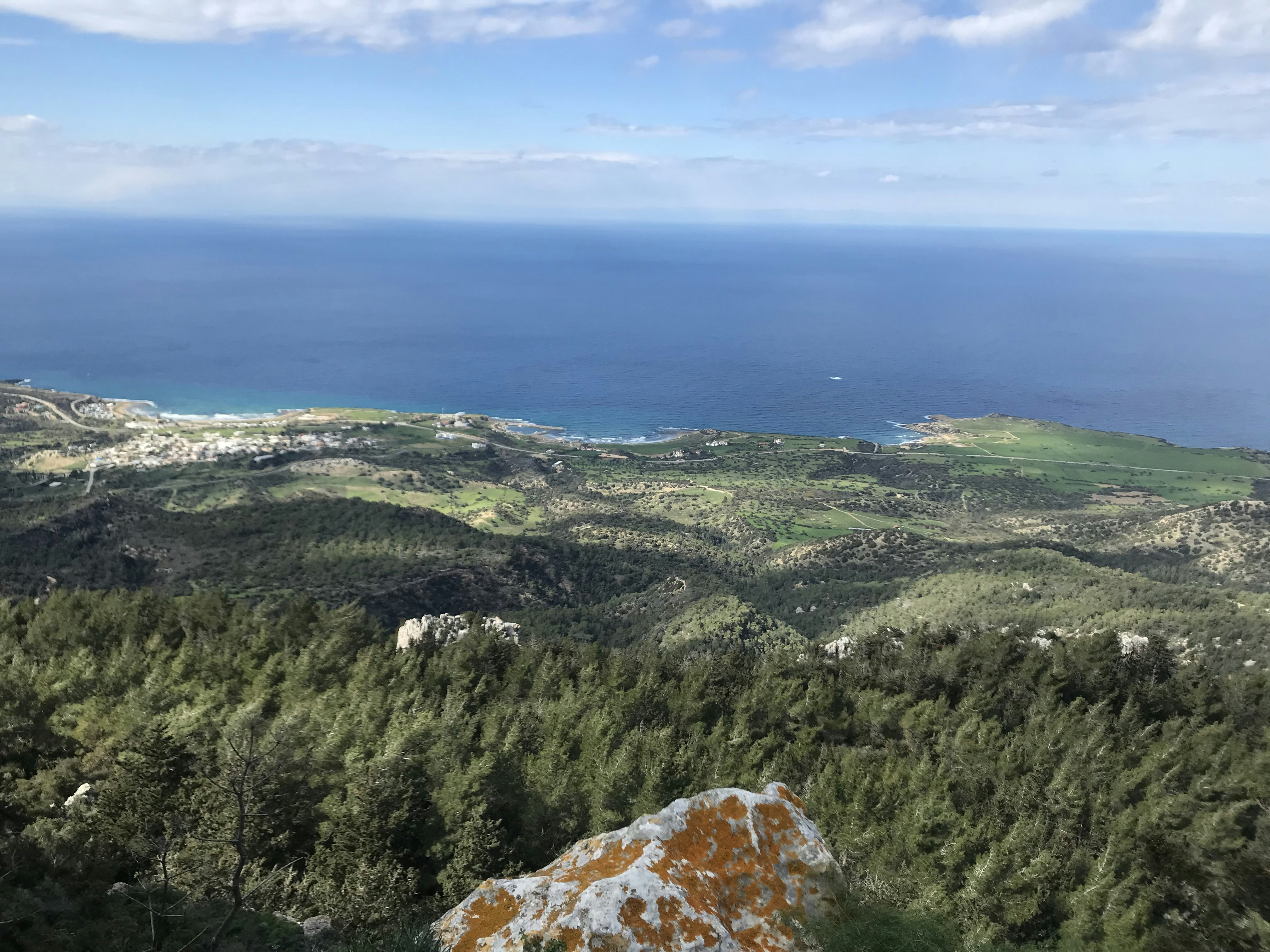 a view of the ocean from the top of a hill