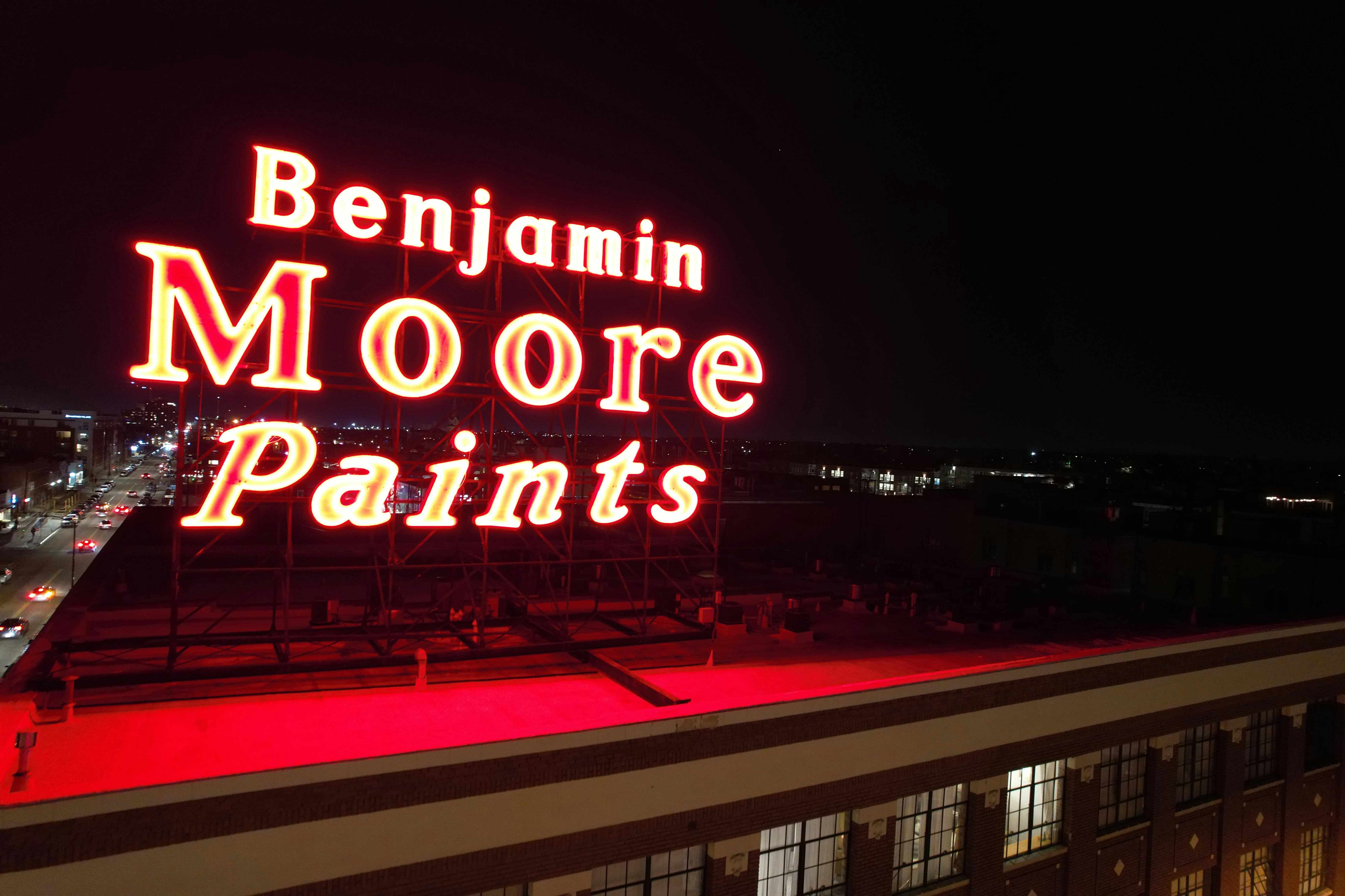 a large neon sign on top of a building