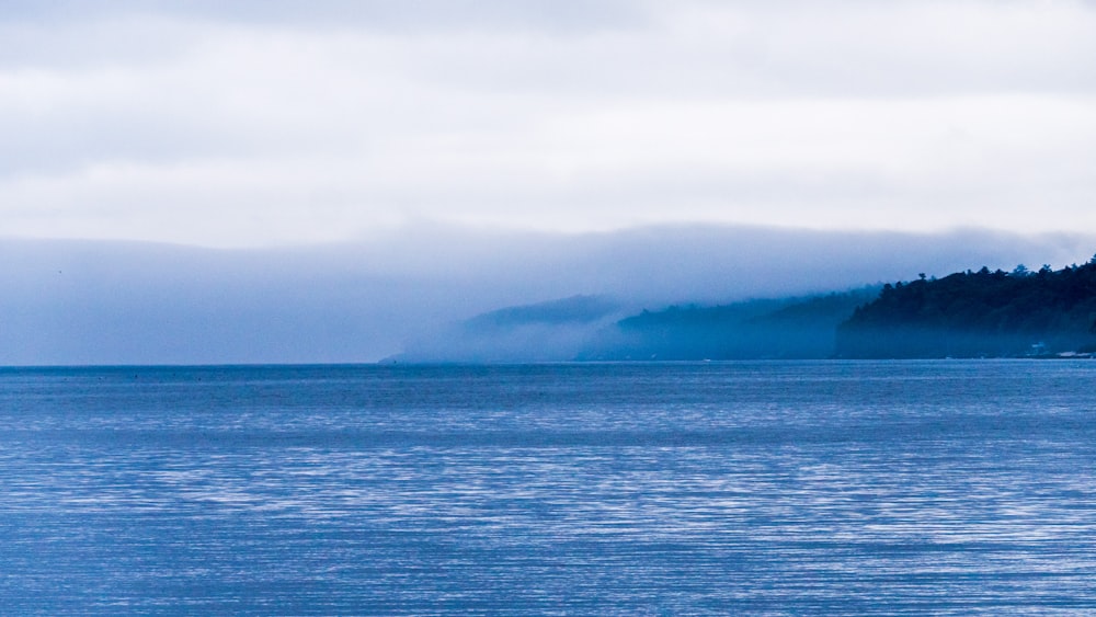 a large body of water with a small island in the distance