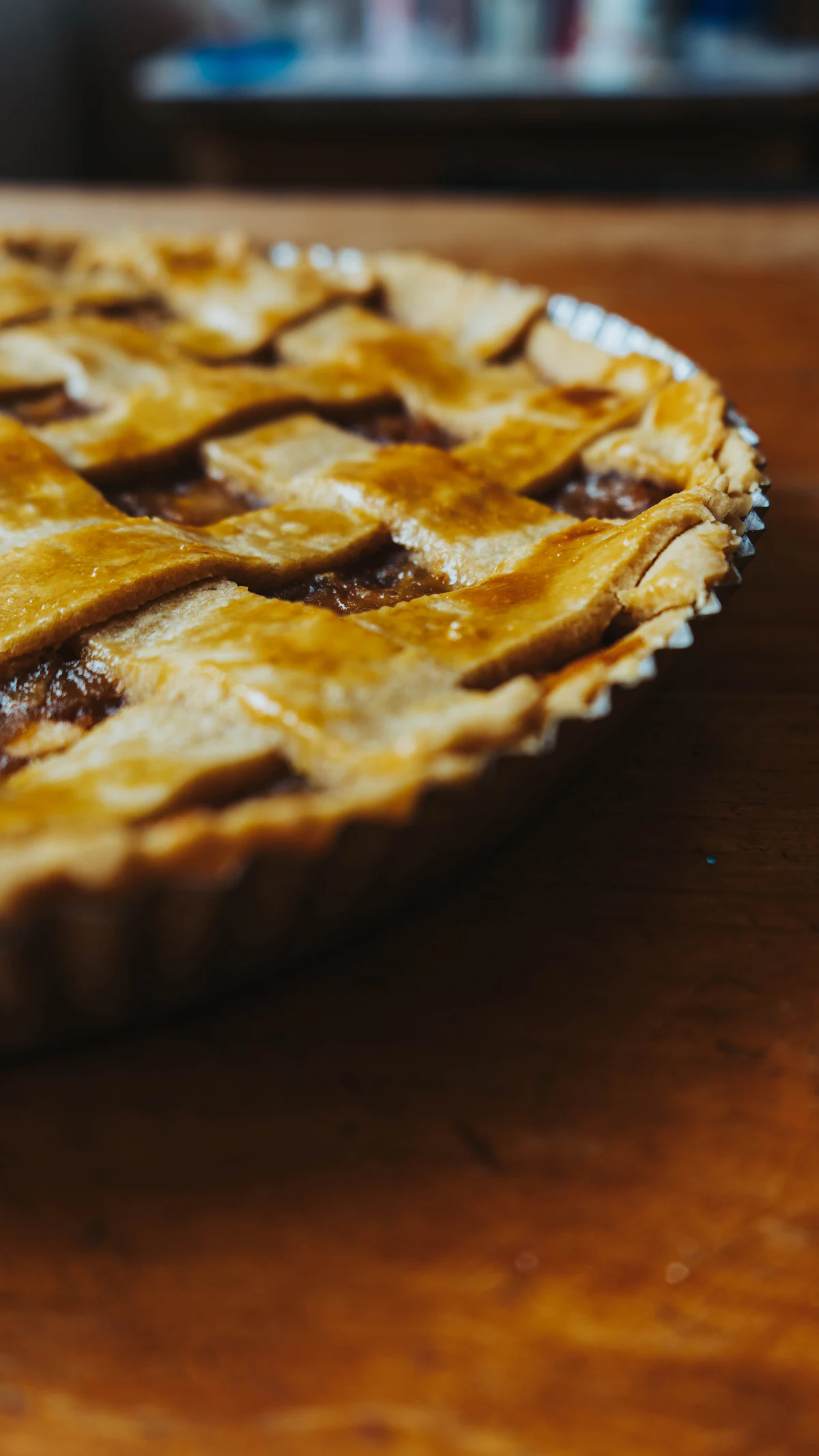 A whole pie with a golden lattice top, shot close