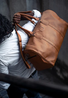 a man carrying a large brown bag on his back