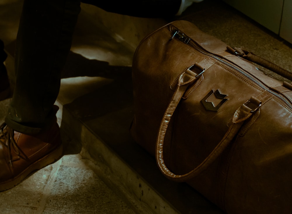 a person standing next to a brown bag