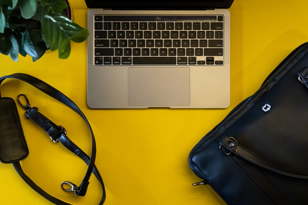 a laptop computer sitting on top of a yellow table