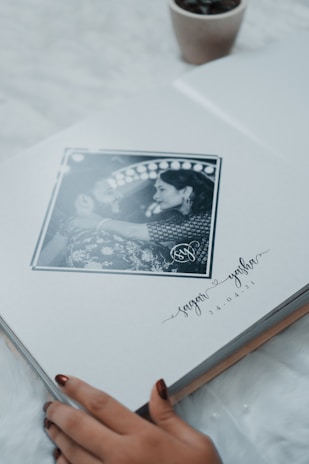 An artistically designed wedding album open to a page of heartfelt memories.