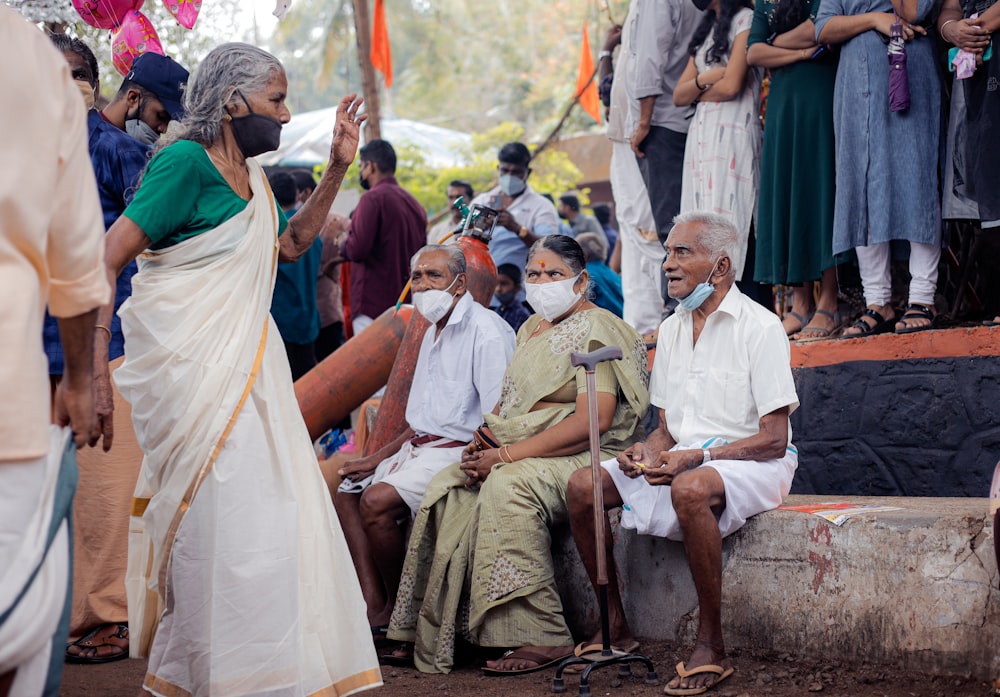 a group of people sitting and standing around each other