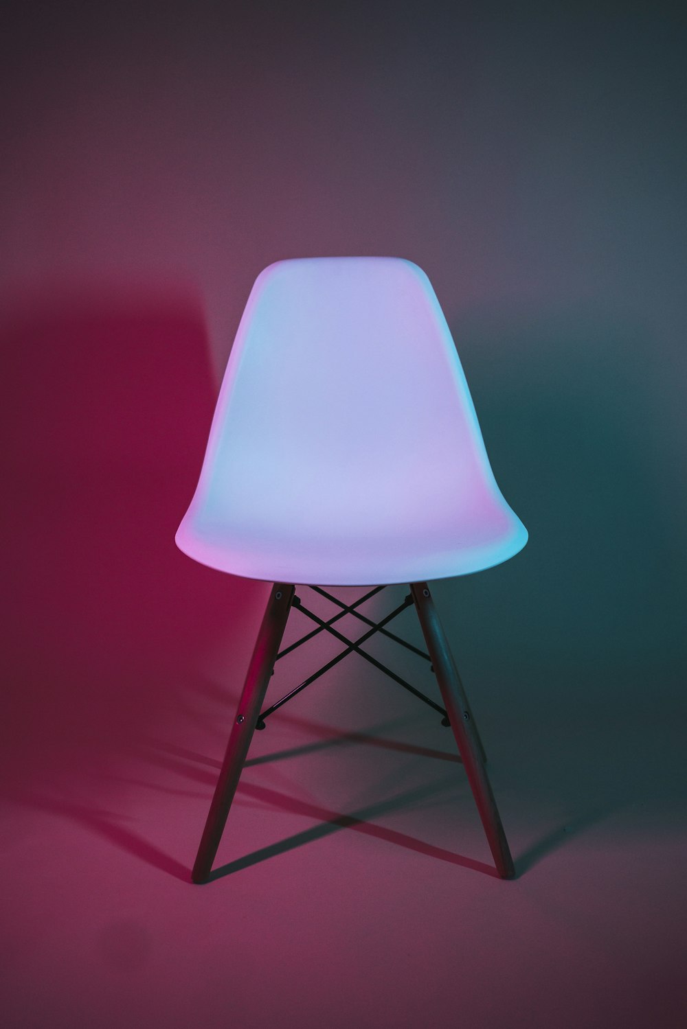 a white chair with a pink light on it