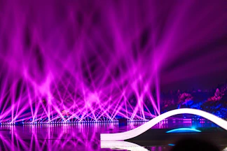 a purple light show is shown in the background