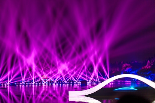 a purple light show is shown in the background