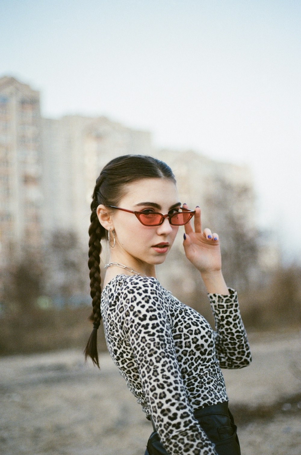 a woman wearing sunglasses and a leopard print top