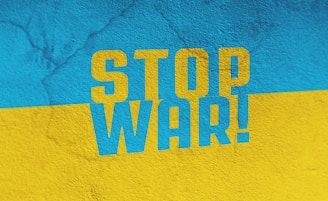 a blue and yellow wall with the words stop war painted on it