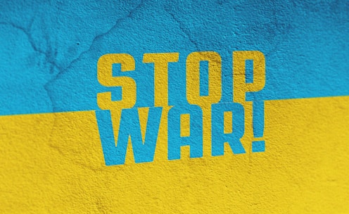 a blue and yellow wall with the words stop war painted on it