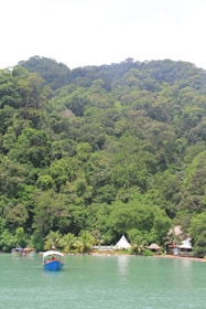 A scenic Malaysian tourist spot with travelers enjoying local culture and natural beauty.