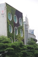 Close-up of the building’s eco-friendly facade with integrated greenery and solar panels.