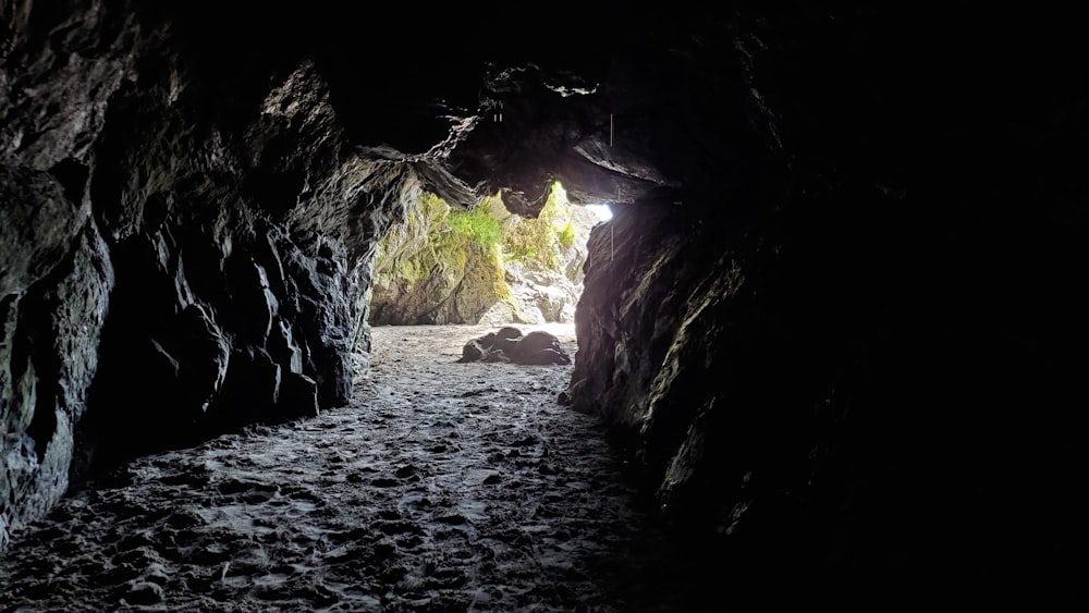 a cave with a light at the end of it
