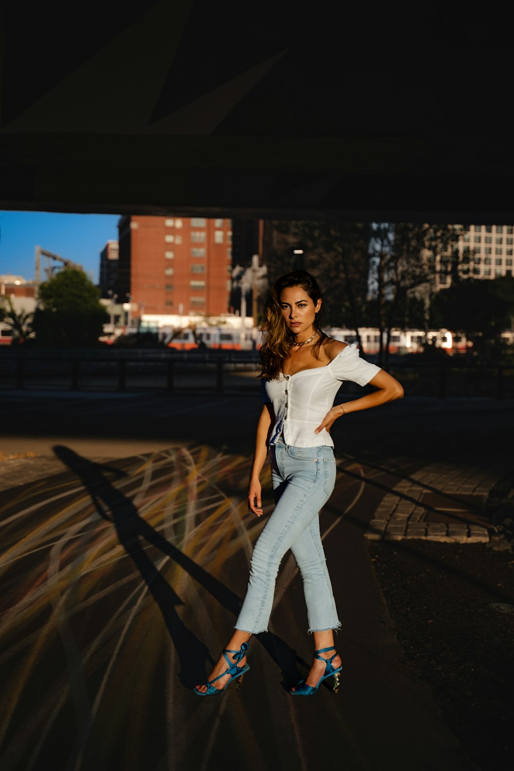 a woman posing for a picture in a city