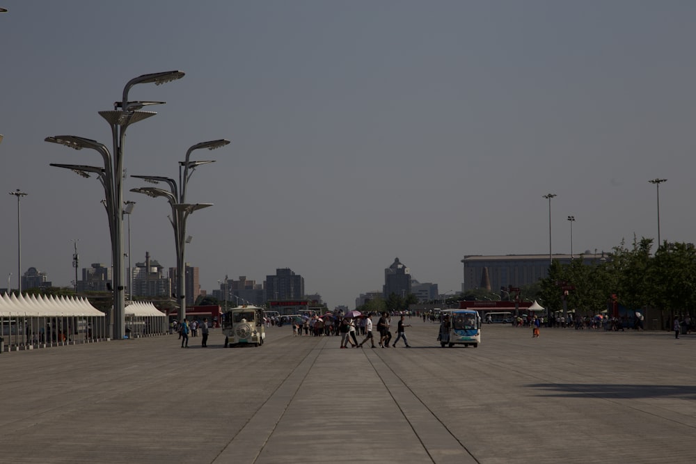 a group of people walking around a parking lot