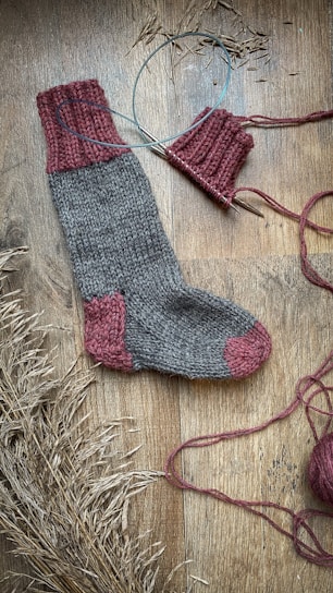 Close-up of plush wool socks arranged on a rustic wooden table