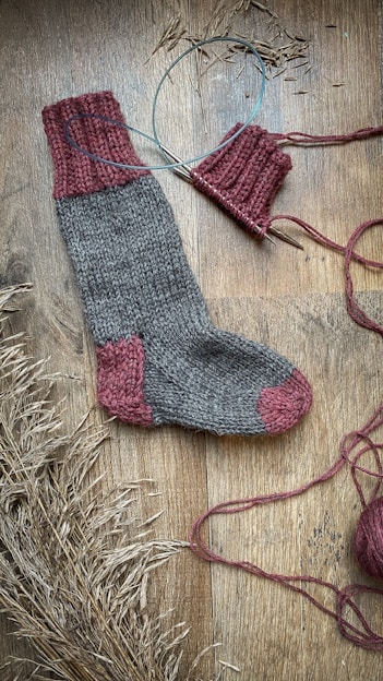 Close-up of plush wool socks arranged on a rustic wooden table