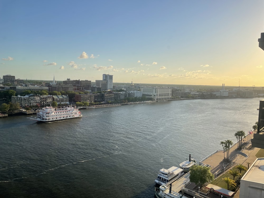 a large boat traveling down a river next to a city