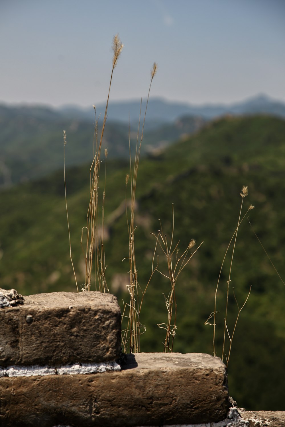 a view of a mountain range from a stone wall