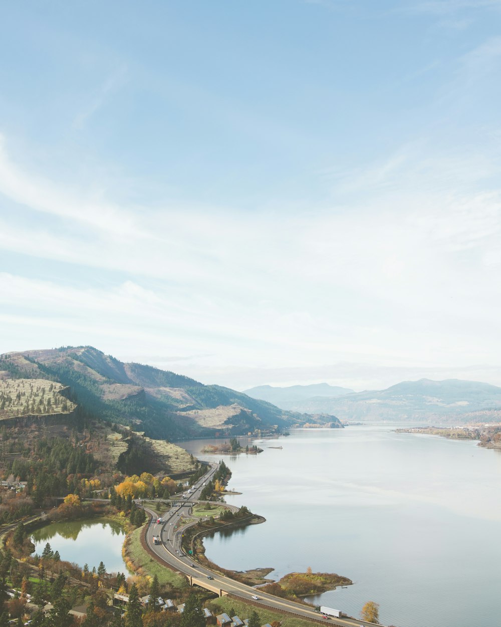 a scenic view of a lake and a highway