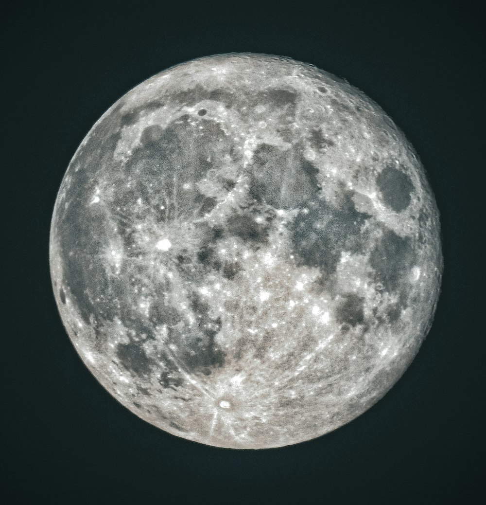 the full moon is seen in the dark sky