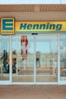a store front with a few people walking in front of it