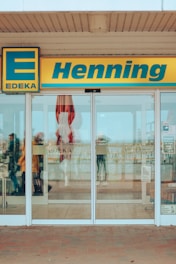 a store front with a few people walking in front of it