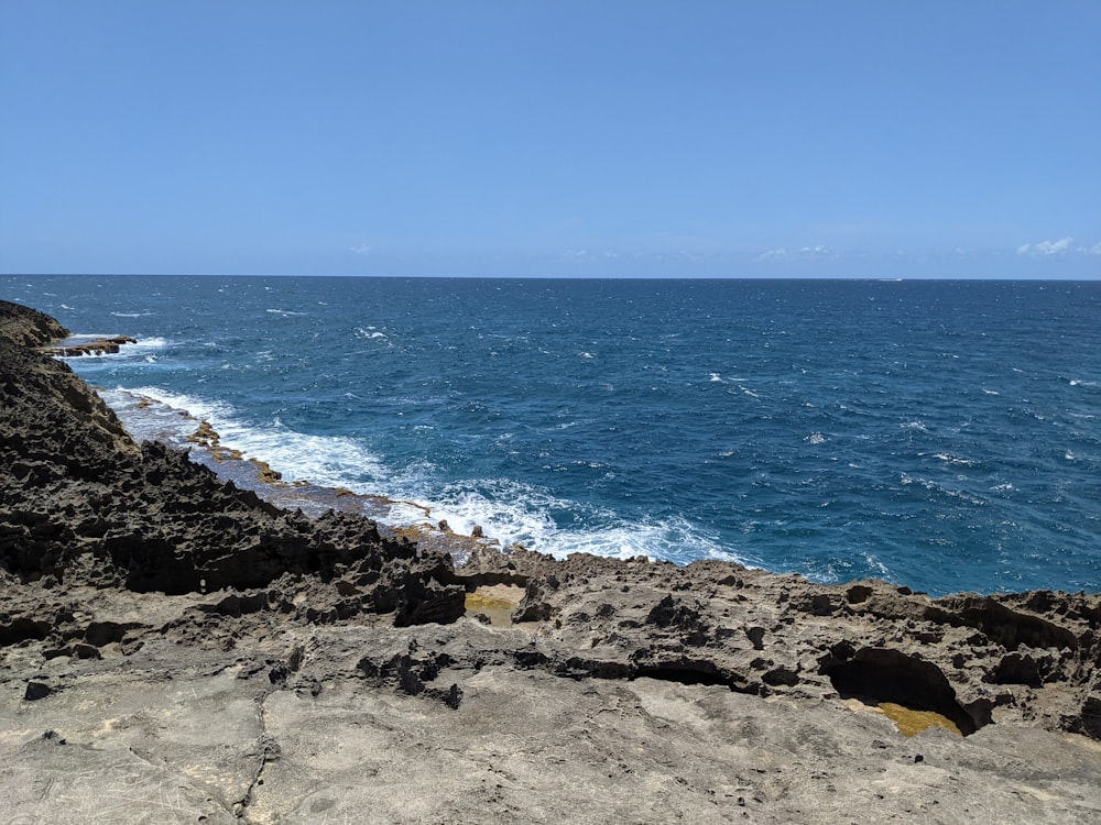 a view of the ocean from a rocky cliff