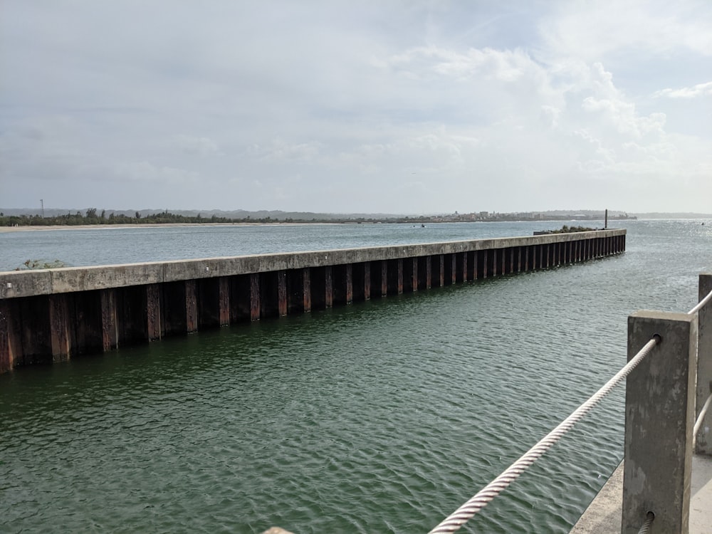 a large body of water next to a pier