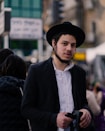 a man in a black hat is holding a camera