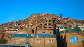 a group of buildings with a mountain in the background