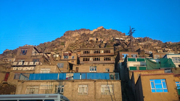 a group of buildings with a mountain in the background