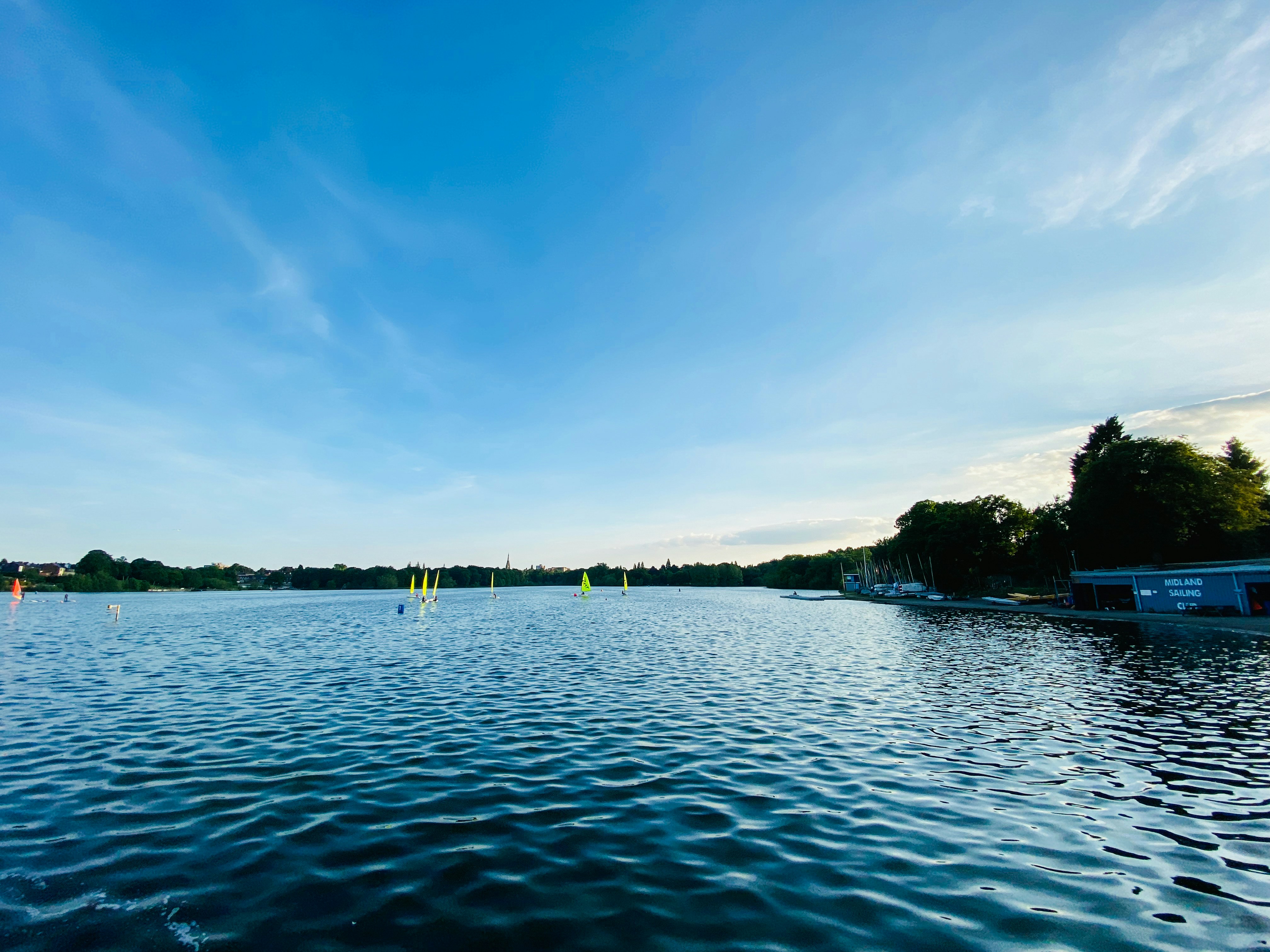 a body of water with boats floating on it, 