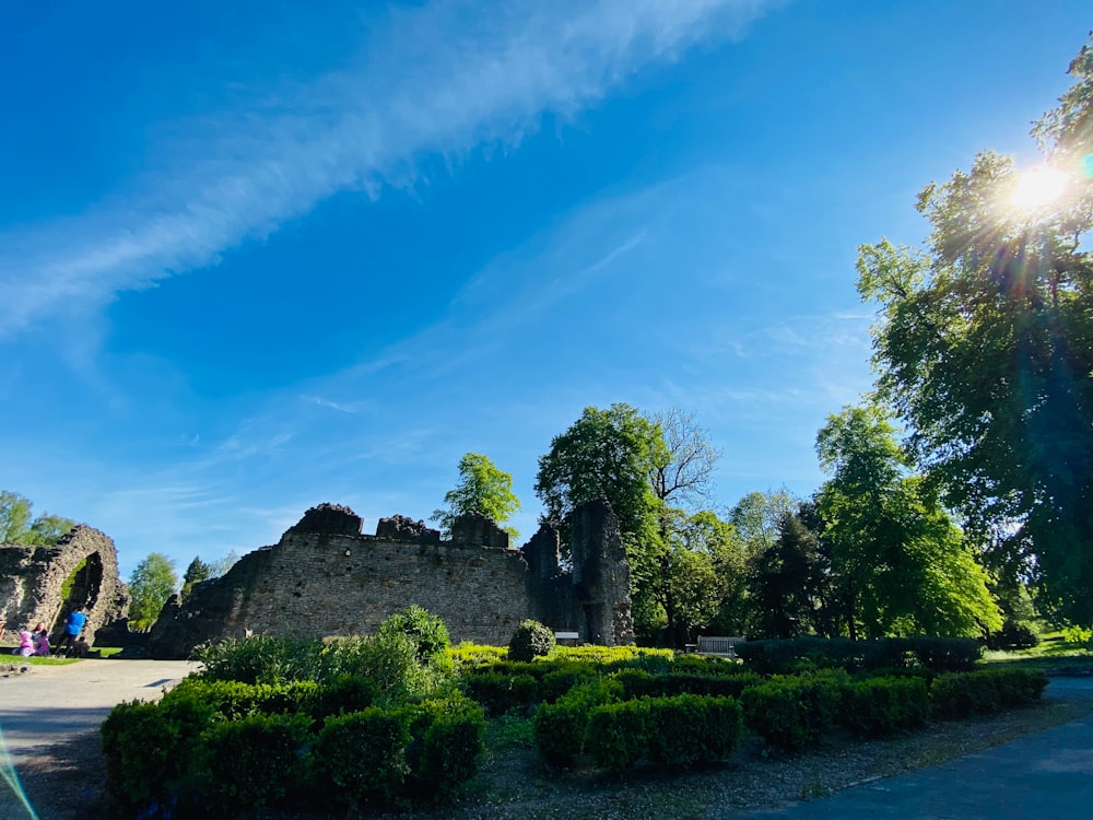 the sun shines brightly over a stone castle