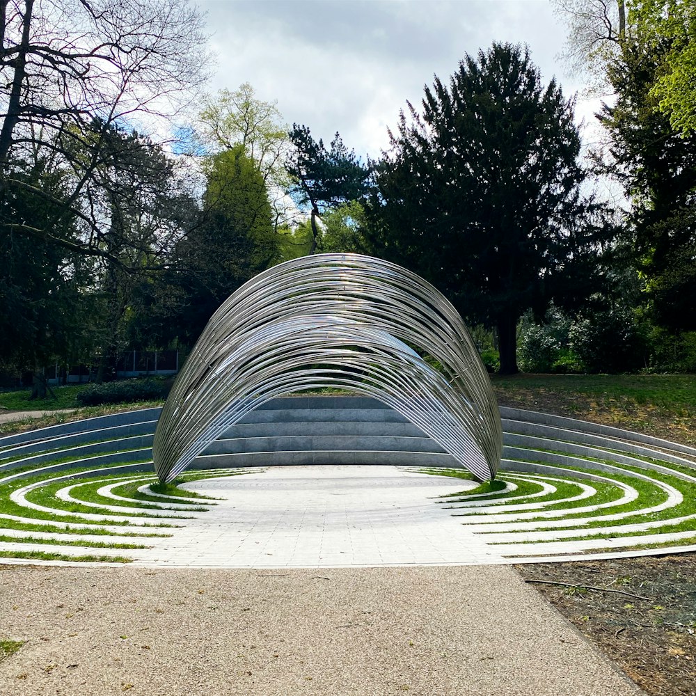 a sculpture in the middle of a circular garden