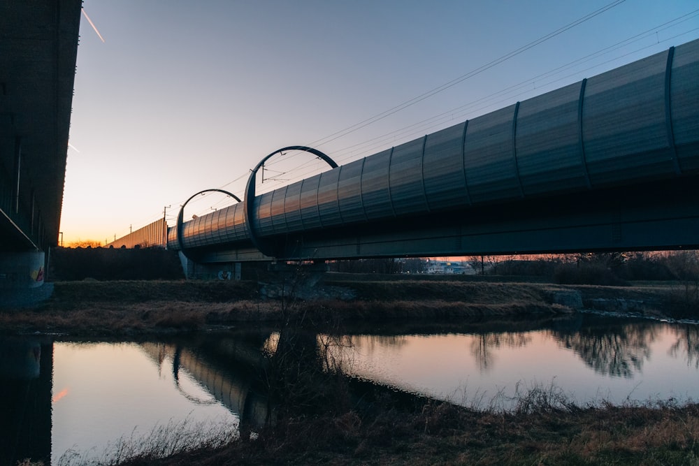 a train traveling over a bridge next to a body of water