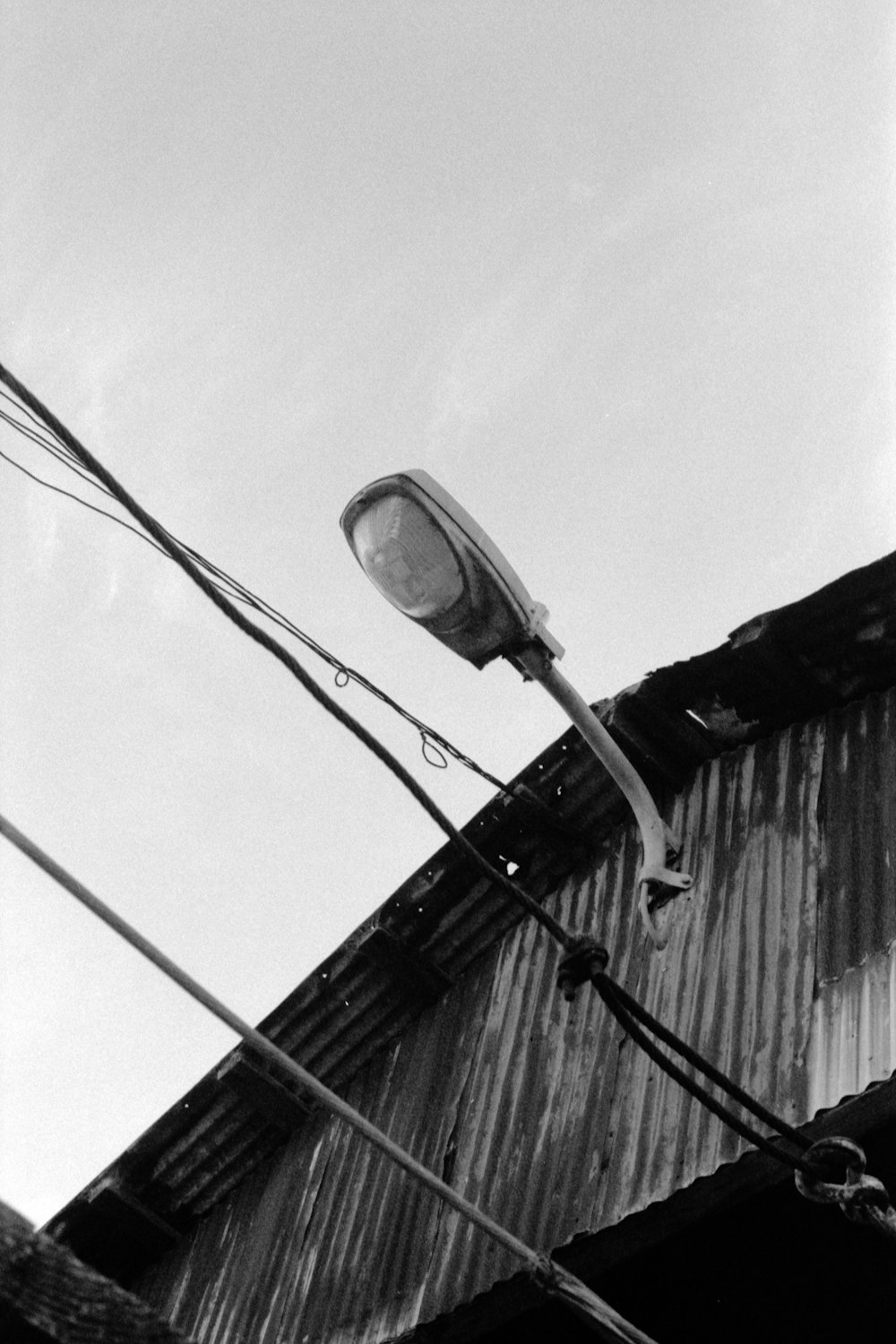 a black and white photo of a street light