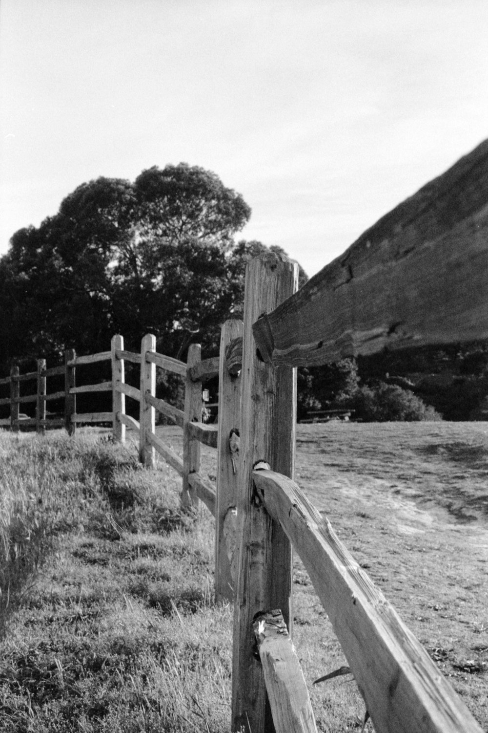 a black and white photo of a wooden fence