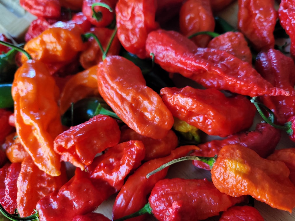 a pile of red peppers sitting on top of a table