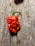 Close-up of a vibrant red chili pepper on a rustic wooden table.