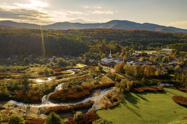 an aerial view of a small town surrounded by mountains