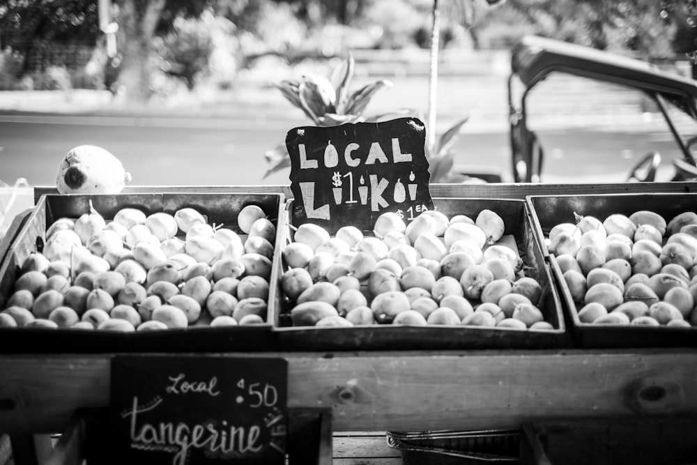 a black and white photo of a fruit stand