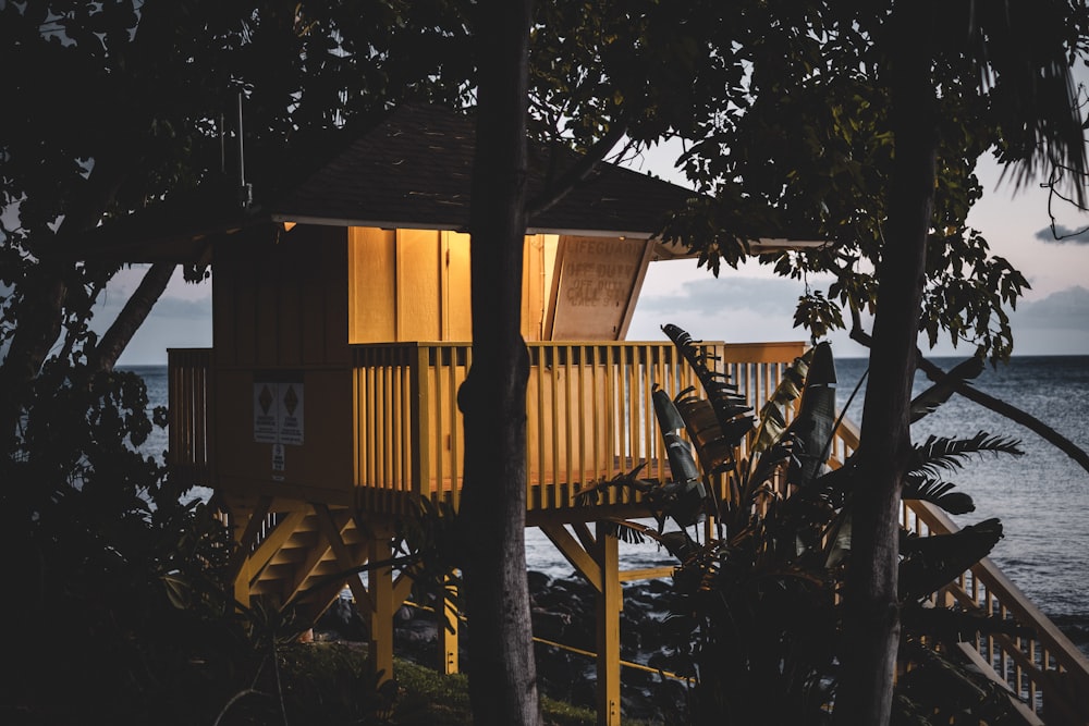 a tree house sitting on top of a lush green hillside